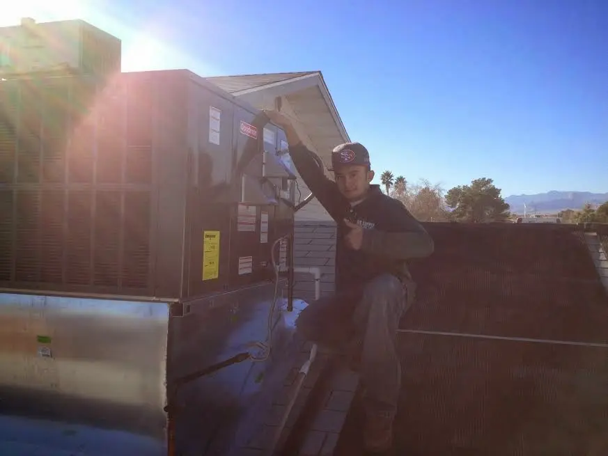 HVAC technician performing Heat Pump Repair on a rooftop unit in Cimarron Hills